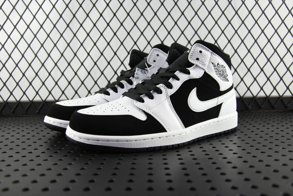 Black and white mid-top sneakers, perforated toe, lace-up with black laces