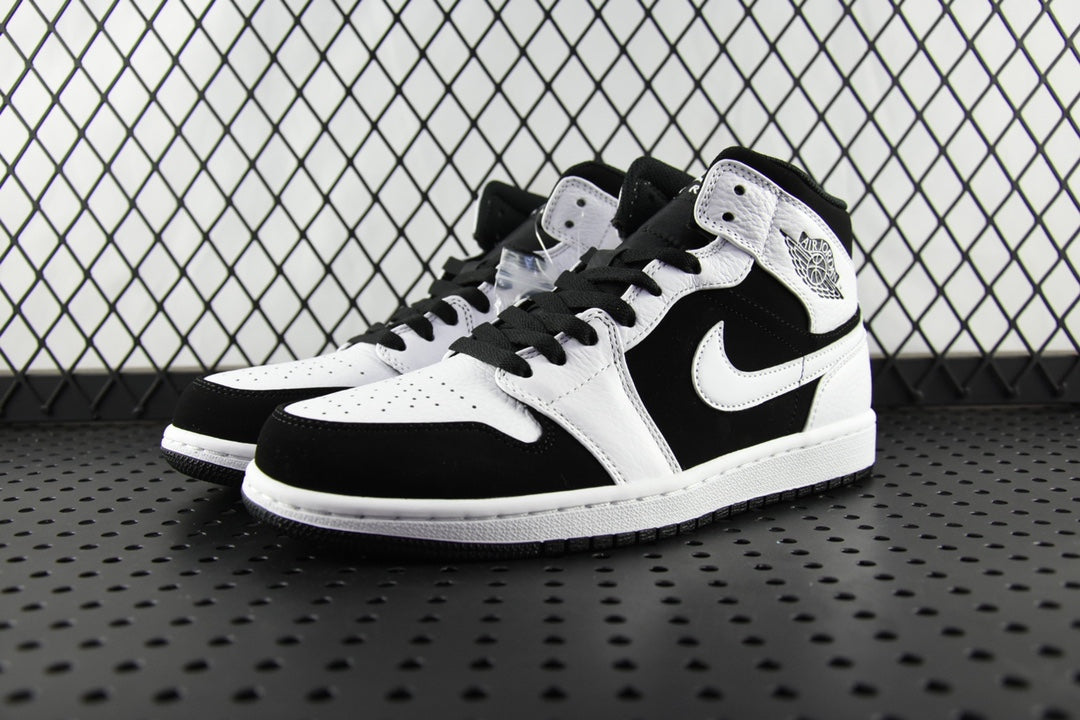 Black and white mid-top sneakers, perforated toe, lace-up with black laces