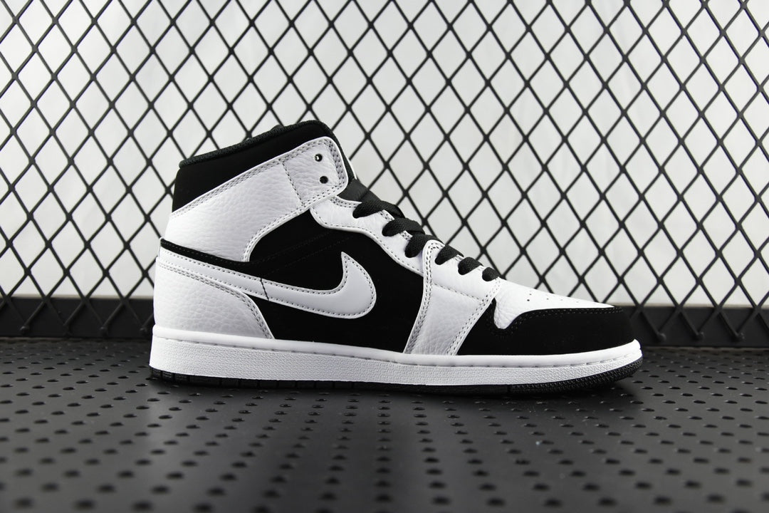 Black and white mid-top sneakers with large Swoosh logo and padded collar