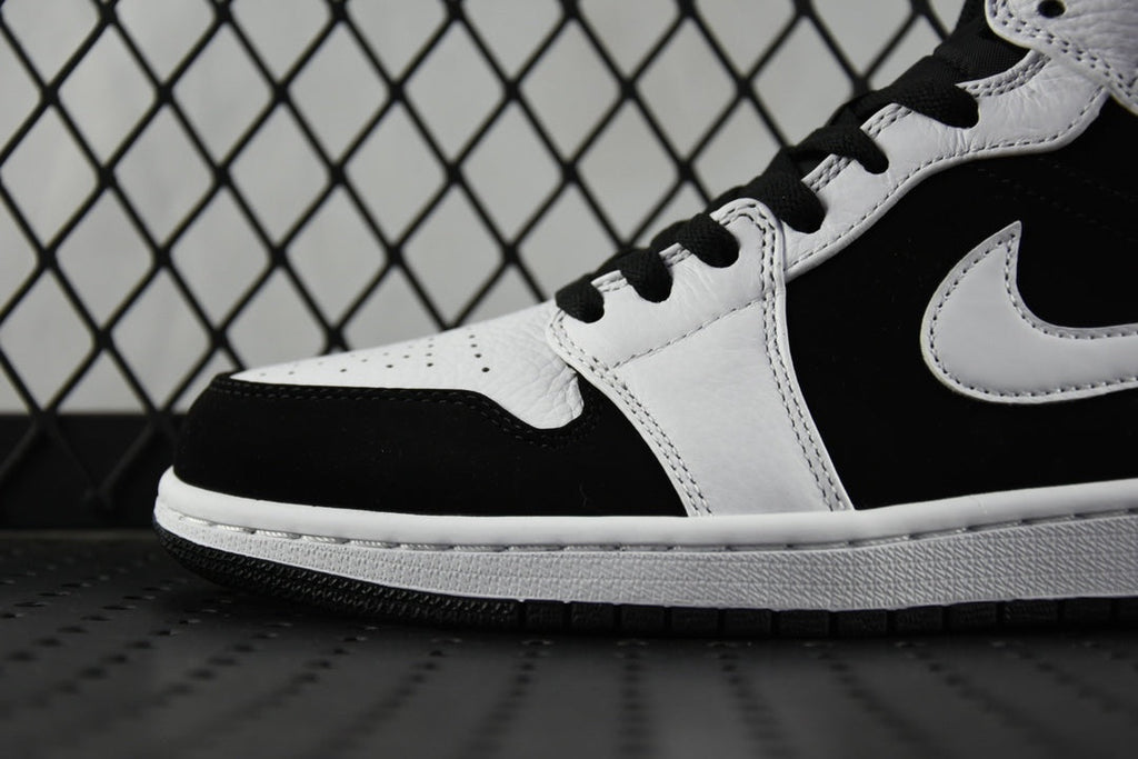 Black and white mid-top sneakers with Swoosh and lace-up eyelets