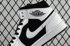 Black and white mid-top sneakers with Air Jordan wings logo on tongue