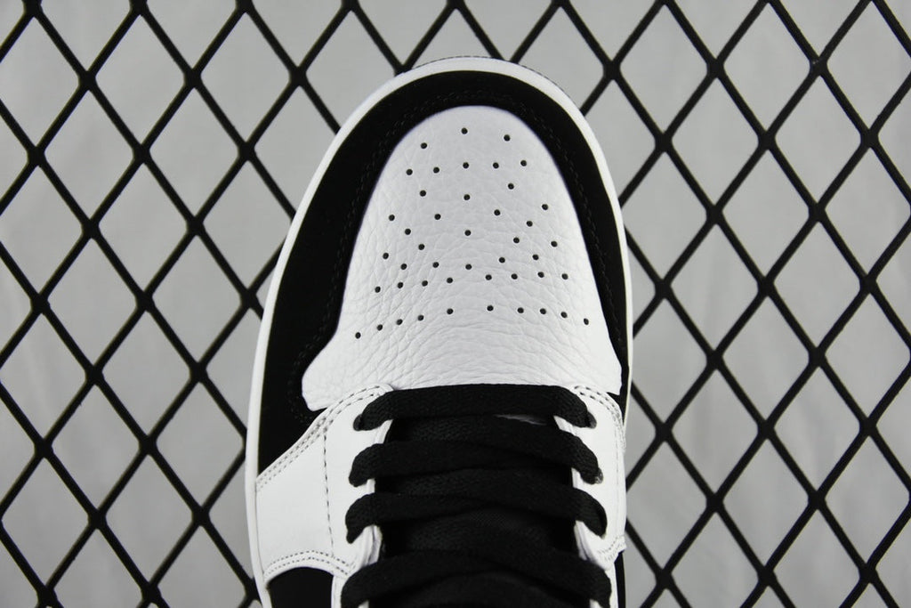 Black and white mid-top sneakers, perforated white toe cap and black laces