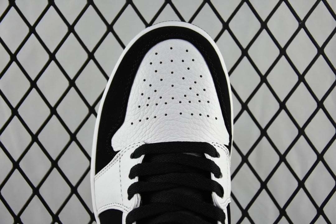 Black and white mid-top sneakers, perforated white toe cap and black laces