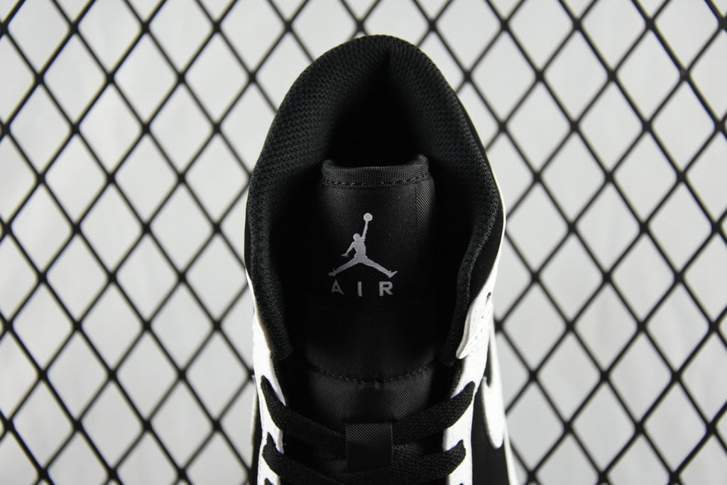Black heel collar with Air Jordan Air logo and black laces on mid-top sneakers