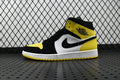 Air Jordan mid-top sneaker in black, white, and yellow with large swoosh