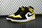 Air Jordan mid-top sneaker pair view with black, white, and yellow color blocking
