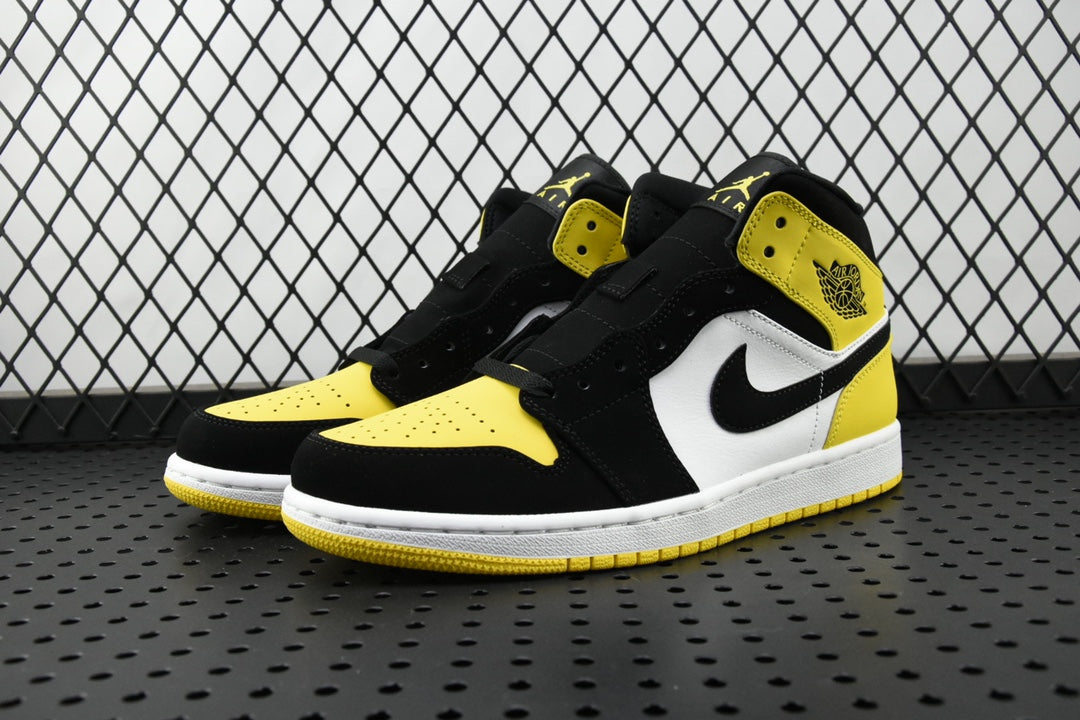 Air Jordan mid-top sneaker pair view with black, white, and yellow color blocking