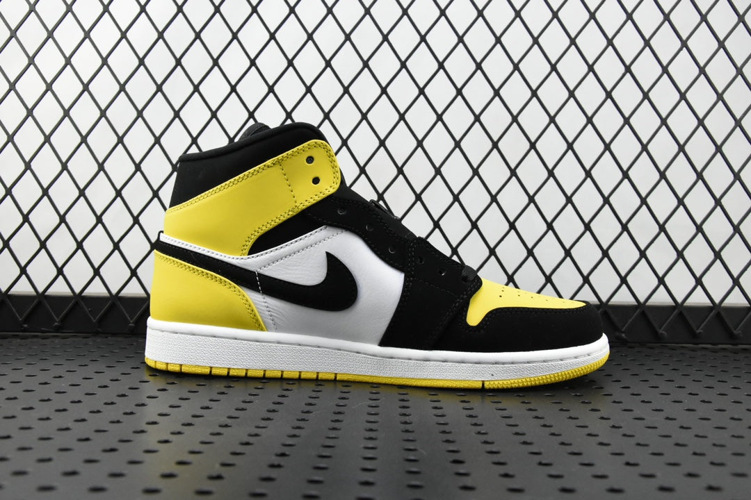 Air Jordan mid-top sneaker side view with yellow ankle panel and black overlays