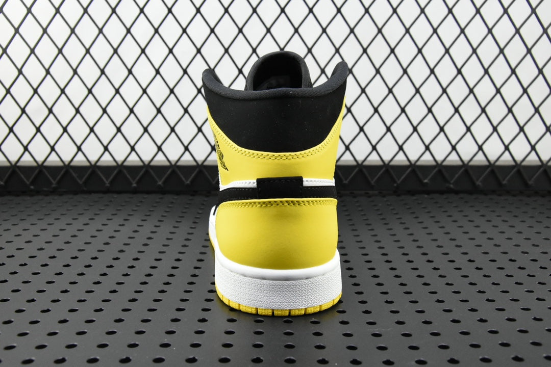 Air Jordan mid-top sneaker heel view in black with yellow collar and white midsole