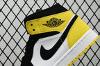 Air Jordan sneaker close-up of tongue label area with yellow top and black/white panels