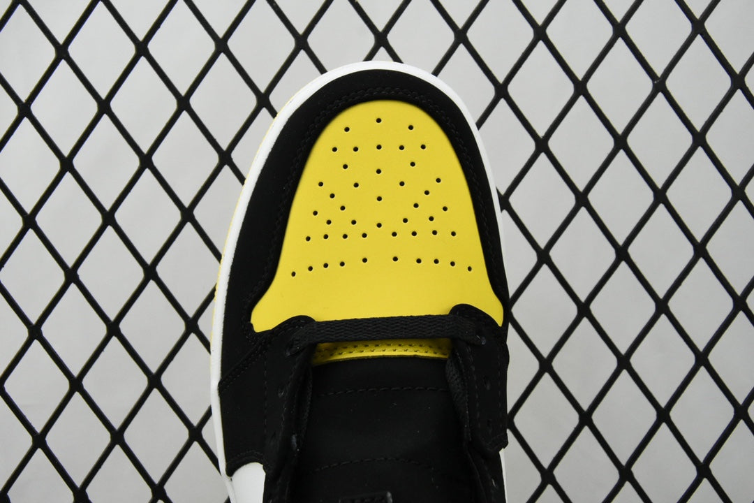 Air Jordan sneaker close-up of black-and-yellow perforated toe cap