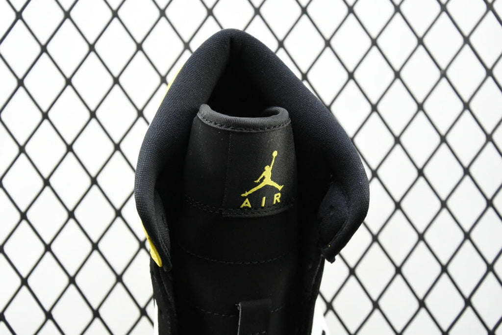 Air Jordan sneaker close-up of black heel with embroidered Air logo in yellow