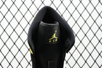 Air Jordan sneaker close-up of black heel with embroidered Air logo in yellow