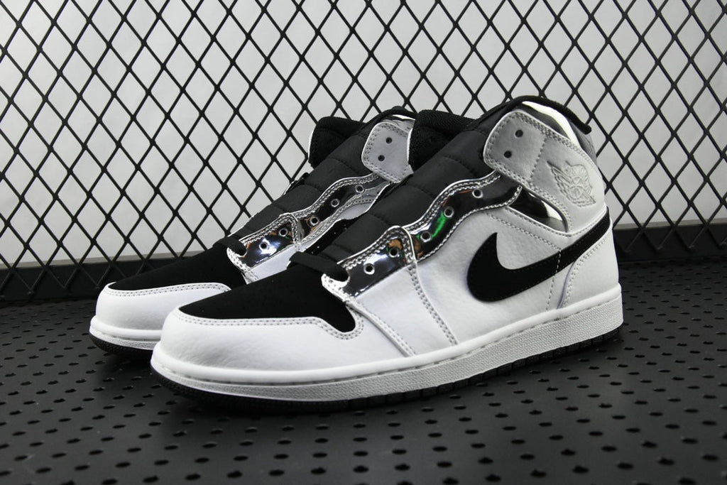 Air Jordan 1 Mid sneakers with white toe and black collar, angled pair view