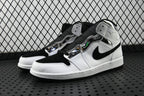Air Jordan 1 Mid sneakers with white toe and black collar, angled pair view