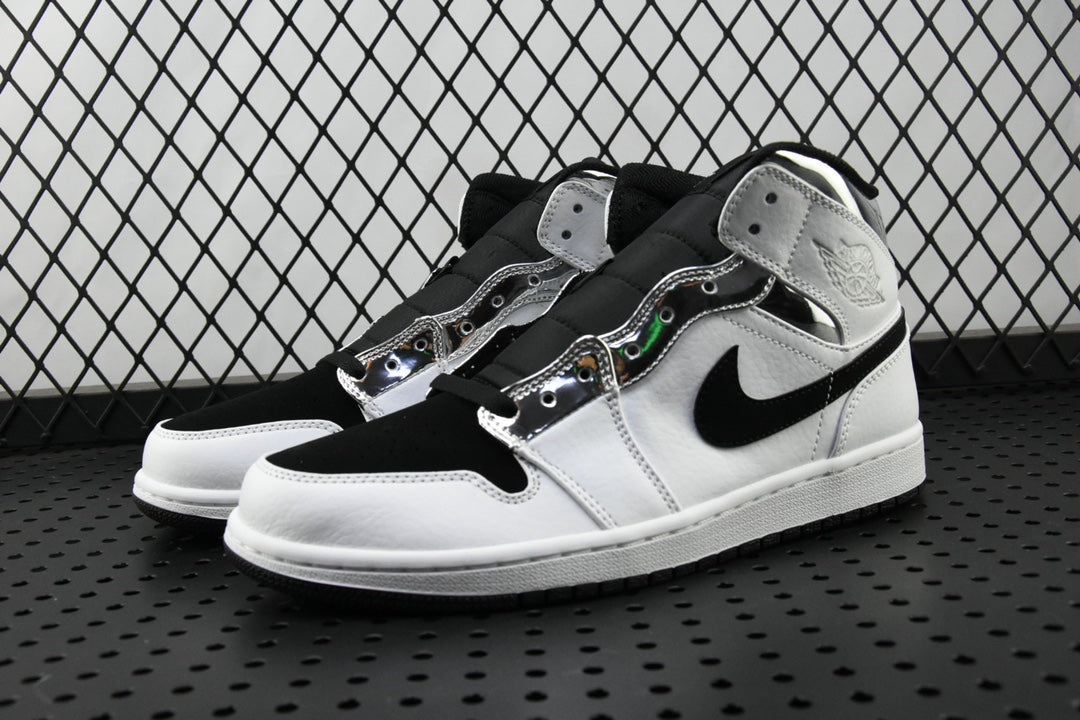 Air Jordan 1 Mid sneakers with white toe and black collar, angled pair view