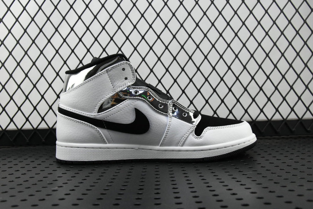 Air Jordan 1 Mid sneakers, white upper with black swoosh and ankle strap, side view