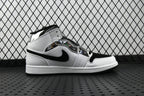 Air Jordan 1 Mid sneakers, white upper with black swoosh and ankle strap, side view