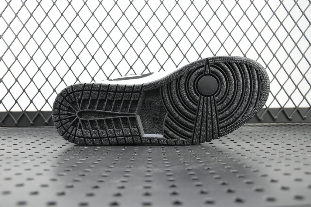 Air Jordan 1 Mid outsole, textured black tread with circular traction pattern