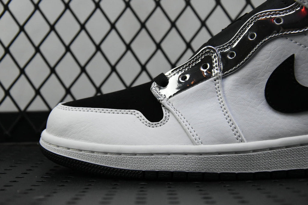 Air Jordan 1 Mid shoe detail, white leather panel with black swoosh and lace holes