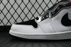 Air Jordan 1 Mid shoe detail, white leather panel with black swoosh and lace holes