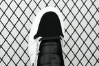 Air Jordan 1 Mid sneakers, front view with black lace and perforated white toe box