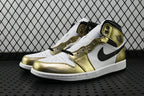 Mid-top sneaker in metallic gold, white, and black with black Nike swoosh and lace-up