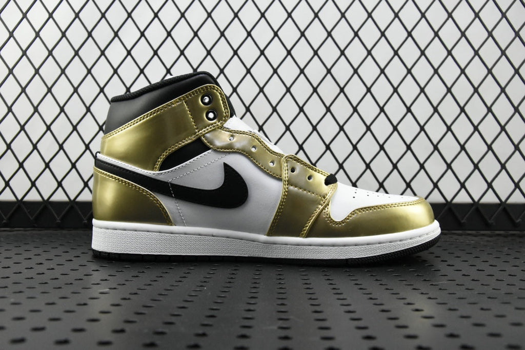 Mid-top Air Jordan sneaker with metallic gold leather, white panels, and black swoosh