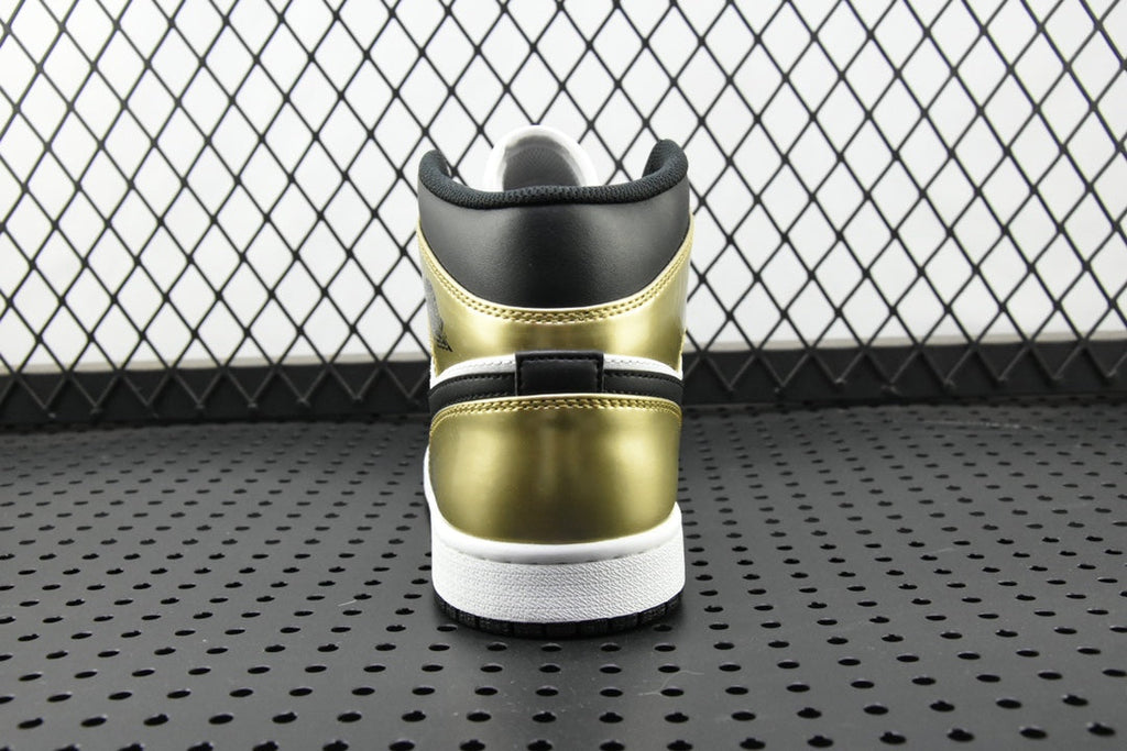 Back view of mid-top sneaker with metallic gold heel and white sole, black collar