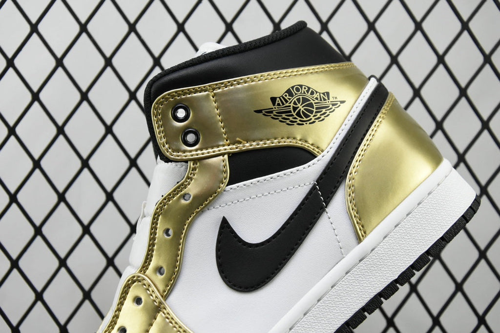Close-up of mid-top sneaker ankle area with gold paneling and black collar