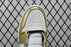 Toe box view of mid-top sneaker with metallic gold trim and perforated white toe