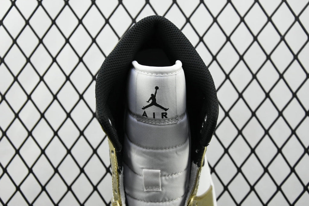 Heel view of mid-top sneaker with AIR Jordan logo on gray lining and metallic gold trim