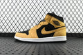 Air Jordan 1 Mid sneaker in black and desert ochre, with Nike swoosh, mid-top