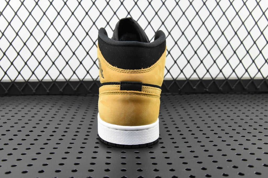 Air Jordan 1 Mid sneaker heel, black collar and desert ochre suede with white sole