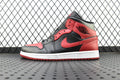 Mid-top Air Jordan 1 sneaker in red, black, and gray with white sole