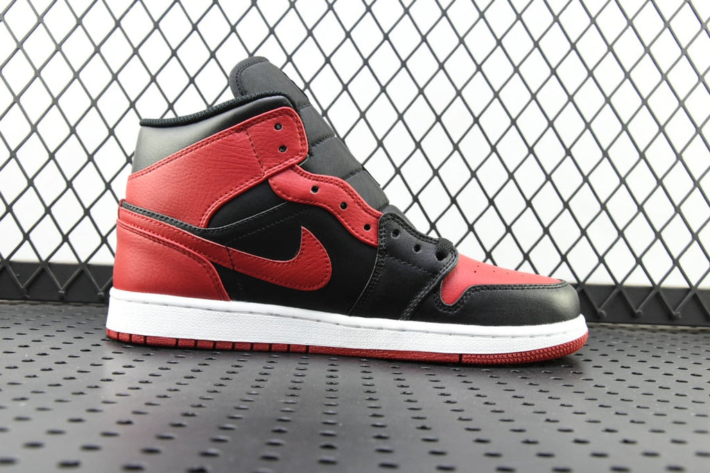 Mid-top sneaker in black, red, and gray with logo detail and white sole