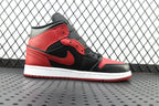 Mid-top sneaker in black, red, and gray with logo detail and white sole