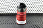 Back view of mid-top sneaker with red heel, black collar, and white sole
