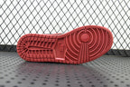 Red rubber outsole tread of a mid-top sneaker with circular pattern