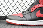 Side view of mid-top sneaker in gray with black overlays, red swoosh, white sole