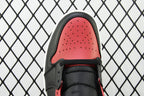 Toe cap of mid-top sneaker with red perforated leather and black laces