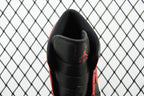 Heel view of mid-top sneaker with black leather upper and red accents