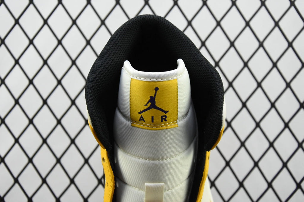 Air Jordan 1 Mid sneakers, white heel with Air Jordan Air logo on black collar, yellow sides