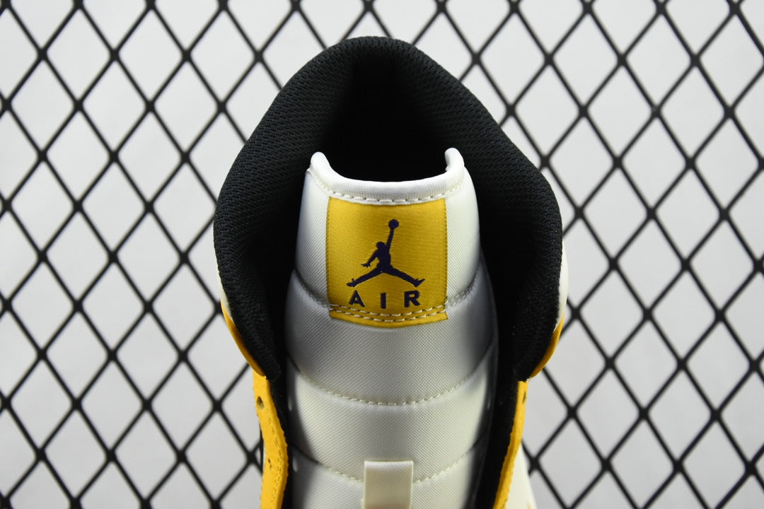 Air Jordan 1 Mid sneakers, white heel with Air Jordan Air logo on black collar, yellow sides