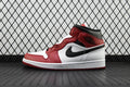 Mid-top leather sneaker in red, white, and black with a visible side swoosh
