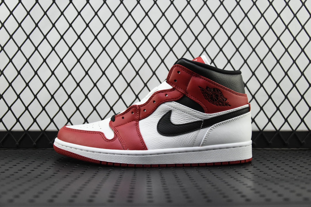 Mid-top leather sneaker in red, white, and black with a visible side swoosh