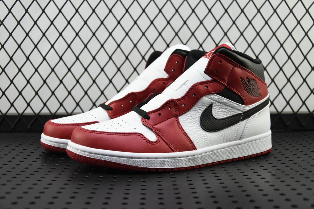 Mid-top sneaker with red and white panels and black swoosh detail
