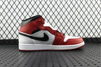 Mid-top sneaker side view in red and white with a black swoosh