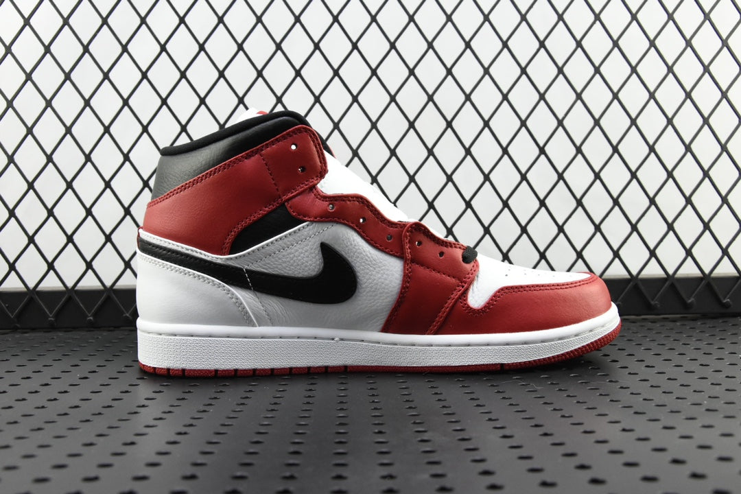 Mid-top sneaker side view in red and white with a black swoosh