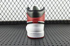 Mid-top sneaker heel view with red collar and white midsole